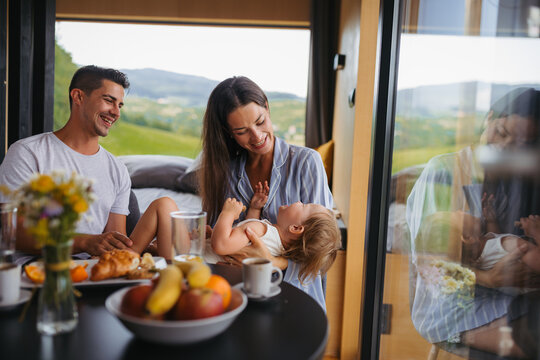 Family spending summer weekend away in cottage house in countryside.