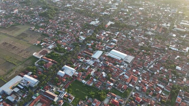 High Angle Aerial View of Densely Populated Residential Area with Red Roofs in Indonesia