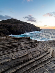 Layered rock formations along Stintino coast during sunset © Luc V. de Zeeuw