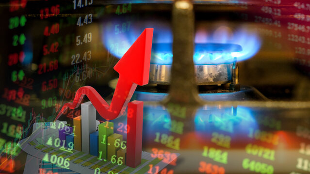 Global natural gas markets are experiencing significant price hikes. The blue flame of a gas burner against a backdrop of flashing stock tickers captures the surging momentum of the energy sector