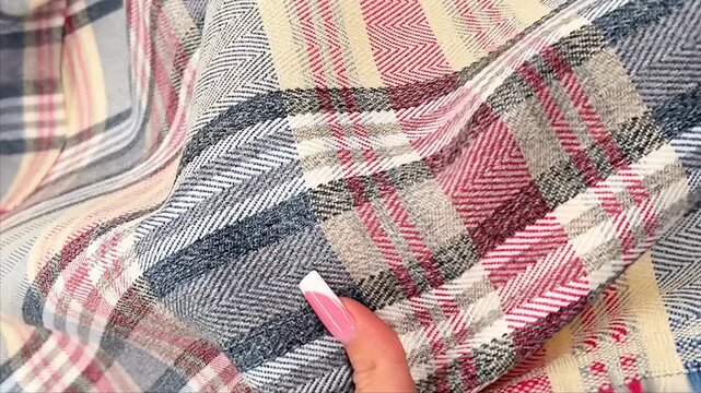 A high quality flannel fabric features a classic plaid pattern in pink grey and cream tones. The soft woven material with a subtle herringbone texture is perfect for cozy autumn apparel and decor.