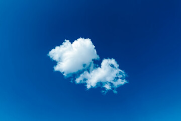 White cloud floating in a clear blue sky © Igor