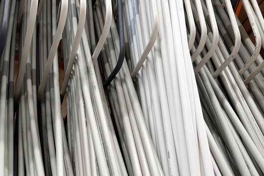 Bundles of white electrical conduit pipes