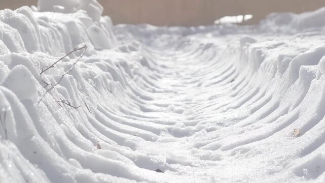 A close-up of truck tire tracks. Deep tire marks from a heavy vehicle in the snow. Winter background.