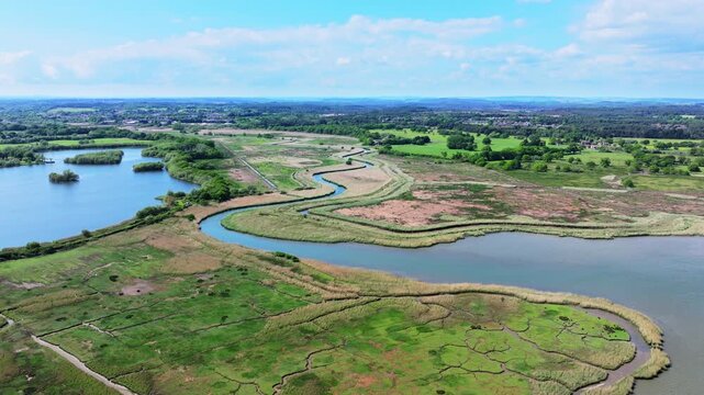 Aerial shot flying upstream of the River Piddle towards a sewerage treatment plant, Dorset, UK