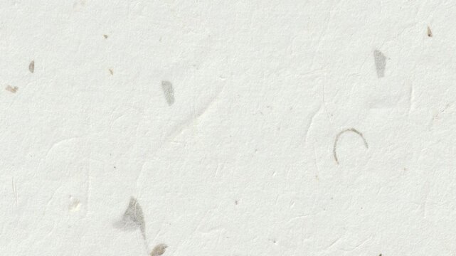 A close-up view of a white surface with scattered debris and fragments on it.