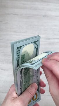 Vertical video. Women's hands count banknotes. Successful management of personal finances and achievement of financial goals. The concept of women's earnings. Close up
