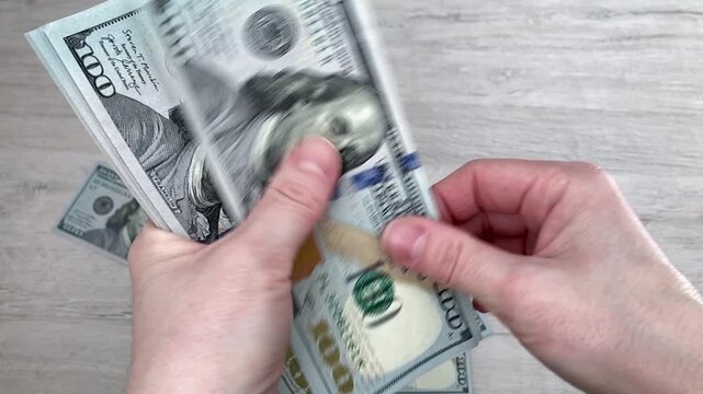 Women's hands are holding banknotes. A woman spends money on her own desires. Financial independence, personal income. An atmosphere of confidence, freedom of choice, and concern for one's own needs
