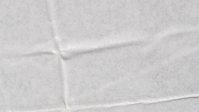 A close-up view of a crumpled paper background with wrinkles and folds.
