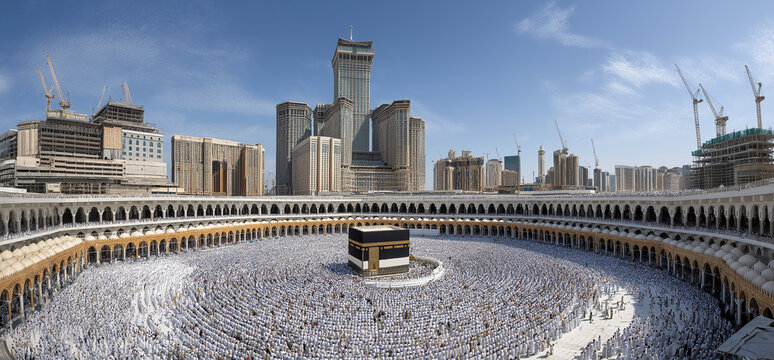 A high angle, panoramic shot captures a vast crowd of pilgrims dressed predominantly in white garments performing tawaf around the kaaba in the grand mosque.