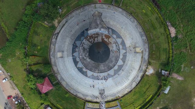 A cinematic topdown drone shot revealing the unique Shiva Linga architecture of the Maha Mrityunjaya Temple in Nagaon, Assam, India.