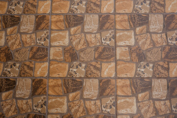 Fototapeta premium Stone tile flooring with geometric brown and beige pattern for architectural background and interior design concept