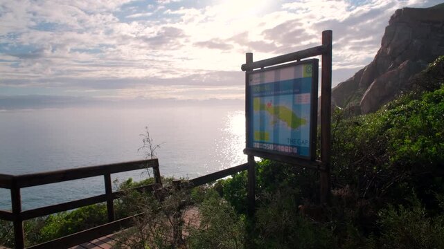 CapeNature tourist map and information board of Robberg hiking trail at sunrise