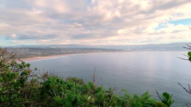 Scenic sunrise cloudscape with view from Robberg toward Plettenberg Beach