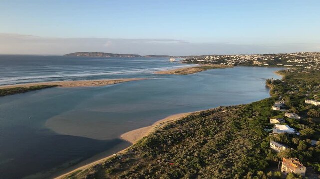 Sunrise aerial view over Keurbooms river lagoon toward mouth and Robberg reserve