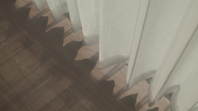Light shine through the curtain draperies at a window in hotel.