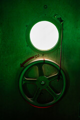Fototapeta premium Metal hatch wheel and porthole inside the diving gondola at Sellin Pier on Rugen island, Germany. Nautical engineering and underwater technology concept.
