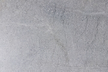 Fototapeta premium Close-up view of textured gray concrete surface with subtle variations and patterns