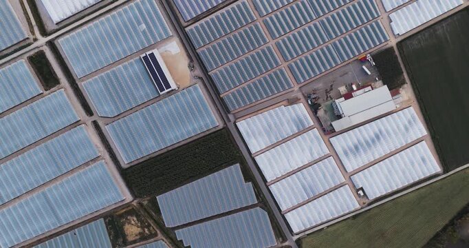 Aerial view of geometric patterns of greenhouses and agricultural fields in the countryside of Paestum, Campania, Italy.