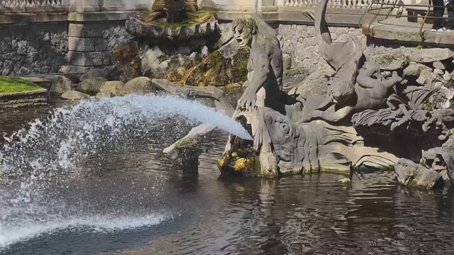 Triton Fountain in D&uuml;sseldorf, Germany, with water splashes and stone sculptures