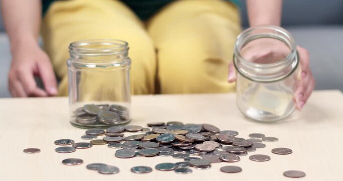 A detailed sequence of pouring coins from jars demonstrating effective money management.