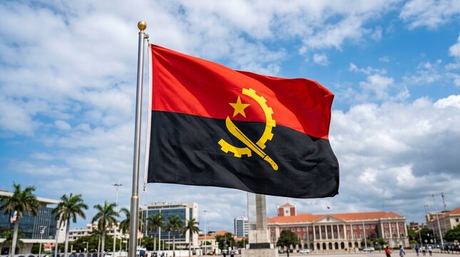 The Angolan flag waves beneath a bright blue sky, symbolizing strength, independence, and unity through its red, black, and yellow emblem of revolution and progress.