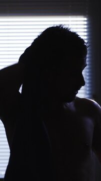 Using a towel to dry up after exercise silhouette at home