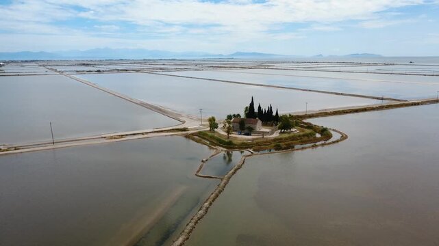 Aerial high angle view of isolated chapel surrounded by lagoon waters