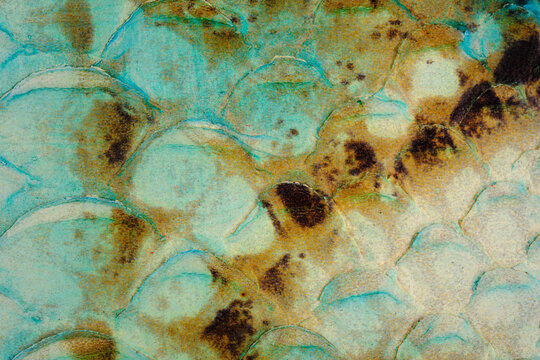 Turquoise reptile leather texture close up with glossy snake scale surface and vintage pattern