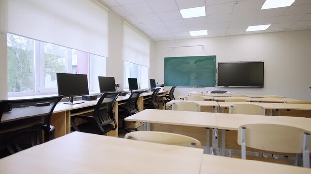 Classroom interior features chalkboards and computer stations. Versatile learning space combines traditional along with modern technology