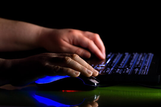 Hands gamer playing a multiplayer game on lan party at home