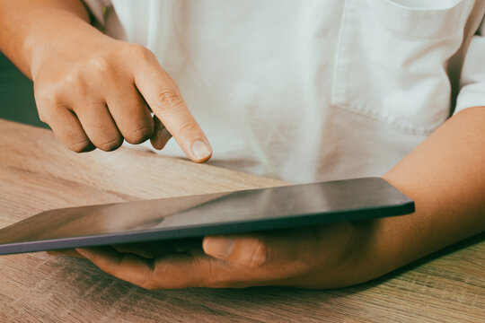 Hand Pointing at Blank Tablet Screen on Wooden Table, Digital Technology Touch Screen Lifestyle Concept