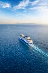 Fototapete Segeln Aerial view of a generic cruise ship sailing into the sunset over blue ocean with copy space as a concept for travel and vacation  © moofushi