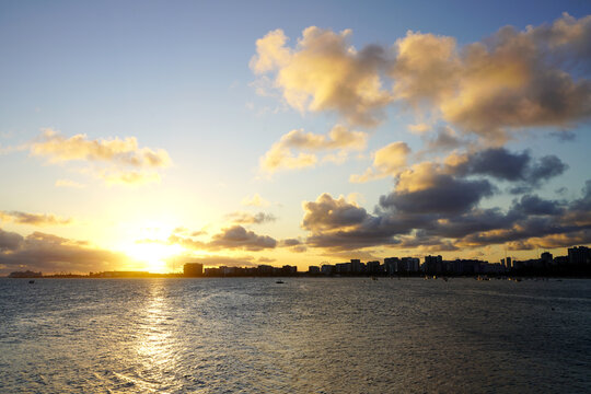 Sunset over coastal city skyline and ocean in Maceio Brazil