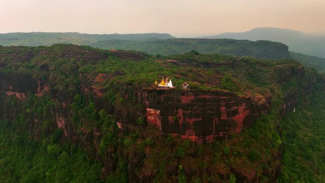 Circling Aerial Establishing Shot of Wat Phu Tok Naga Temple in Vibrant Remote Landscape, Thailand