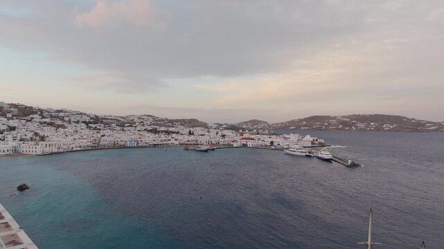Paralia Choras Mikonou, Mykonos island with white buildings and calm sea under soft evening light, Cyclades, Greece