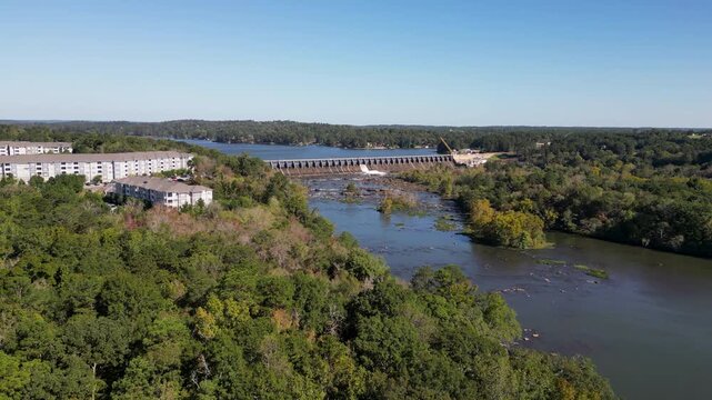 Oliver Dam on Chattahoochee River between Columbus Georgia and Phenix City Alabama built 1959 by Georgia Power forms Lake Oliver with spillway and shoal channel as drone push in