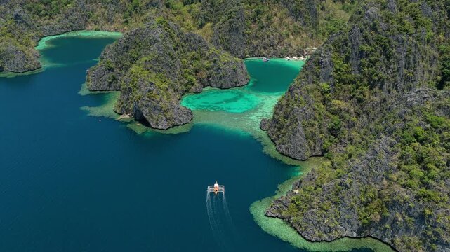 Coron Island Turquoise Blue water and Cliffs Boat Aerial Philiipines