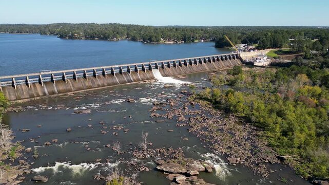 Oliver Dam on the Chattahoochee River operated by Georgia Power with four turbines and 60 MW capacity forming Lake Oliver reservoir with steady spillway release into rocky downstream channel static