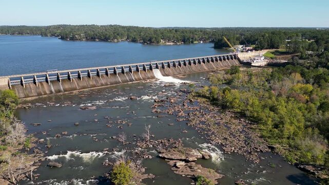 Oliver Dam on Chattahoochee River between Columbus Georgia and Phenix City Alabama releases flow over bedrock shoals with riffle pool sequences and exposed channel bars shaped by regulated discharge