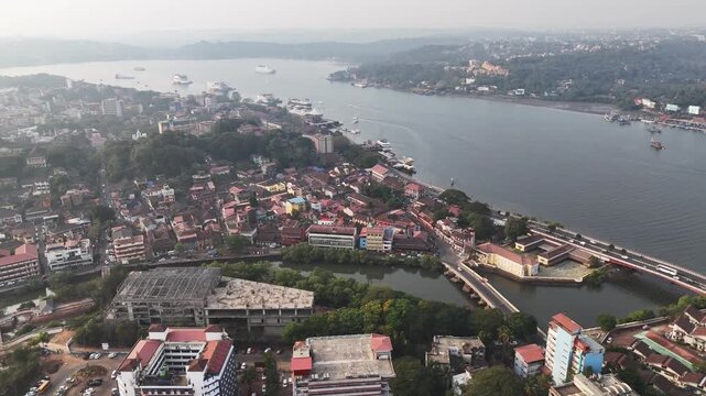 Wide cinematic aerial footage of entire Panaji City, Sao Tome Goa state, showcasing layered infrastructure, flowing traffic, and Atal Setu extending across the river.