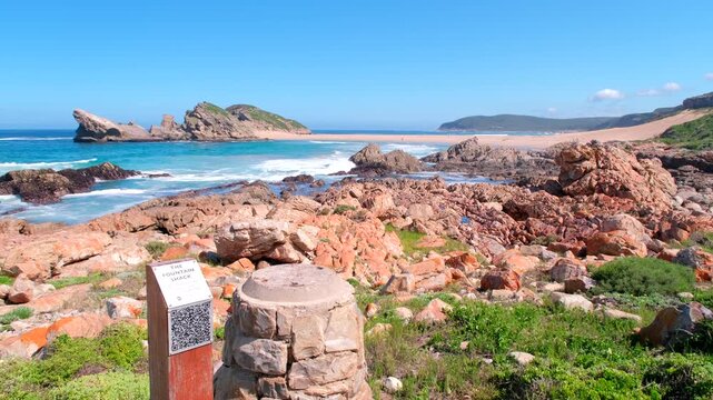 The Fountain Shack QR code on post on Robberg hiking trail, view of The Island