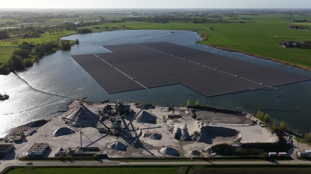 Floating solar panel farm on a lake with sand and gravel quarry
