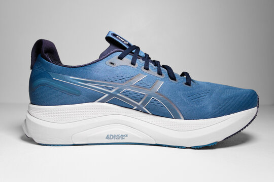 kent, uk, 01.01.2026 ASICS GEL-KAYANO 32 running shoes in Winter Sea Midnight colorway isolated on clean studio background with modern athletic design. Hipster run clubs.