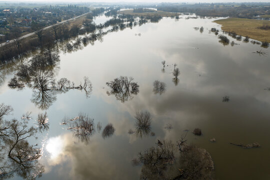 Aerial view of flooded river valley with submerged trees and sky reflections on the water surface near the town Kedainiai, Kaunas County, Lithuania.