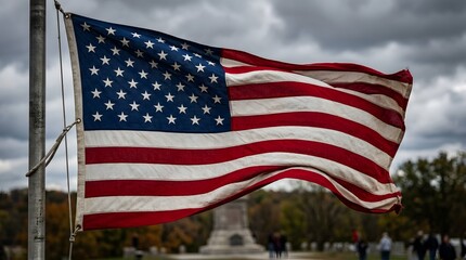 Fototapeta premium Waving american flag on flag day with memorial in background