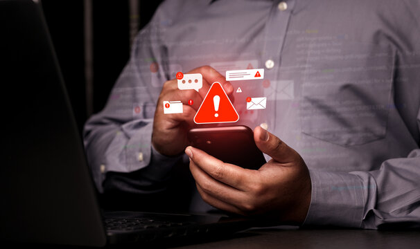 A close-up of a person using a mobile phone surrounded by warning symbols, representing mobile banking fraud, SMS phishing (smishing), and online security threats in the 2026 digital era.