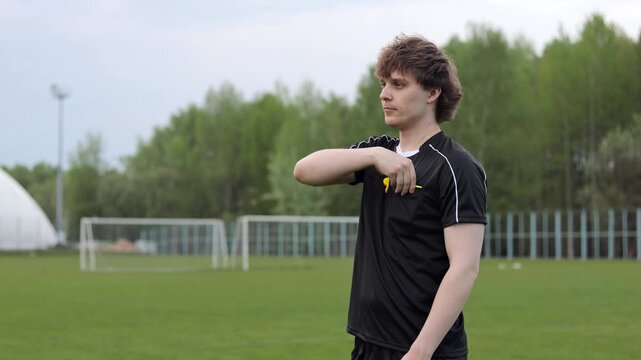 Referee shows yellow card during soccer match at the stadium. Close up