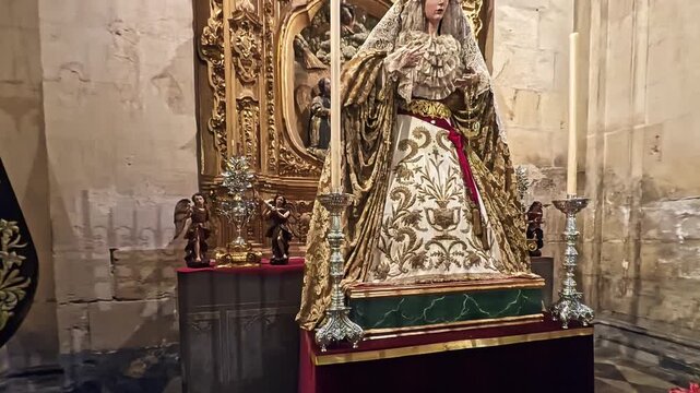 Ornate Virgin Mary Statue on Church Altar With Candles and Gold Embellishments, Granada cathedral, Spain
