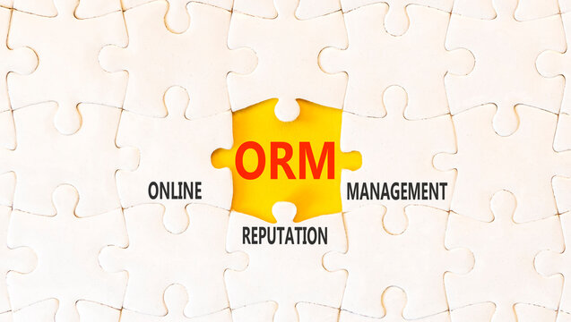ORM online reputation management symbol. Concept words ORM online reputation management on beautiful white puzzles. Beautiful yellow background. Business ORM concept. Copy space.